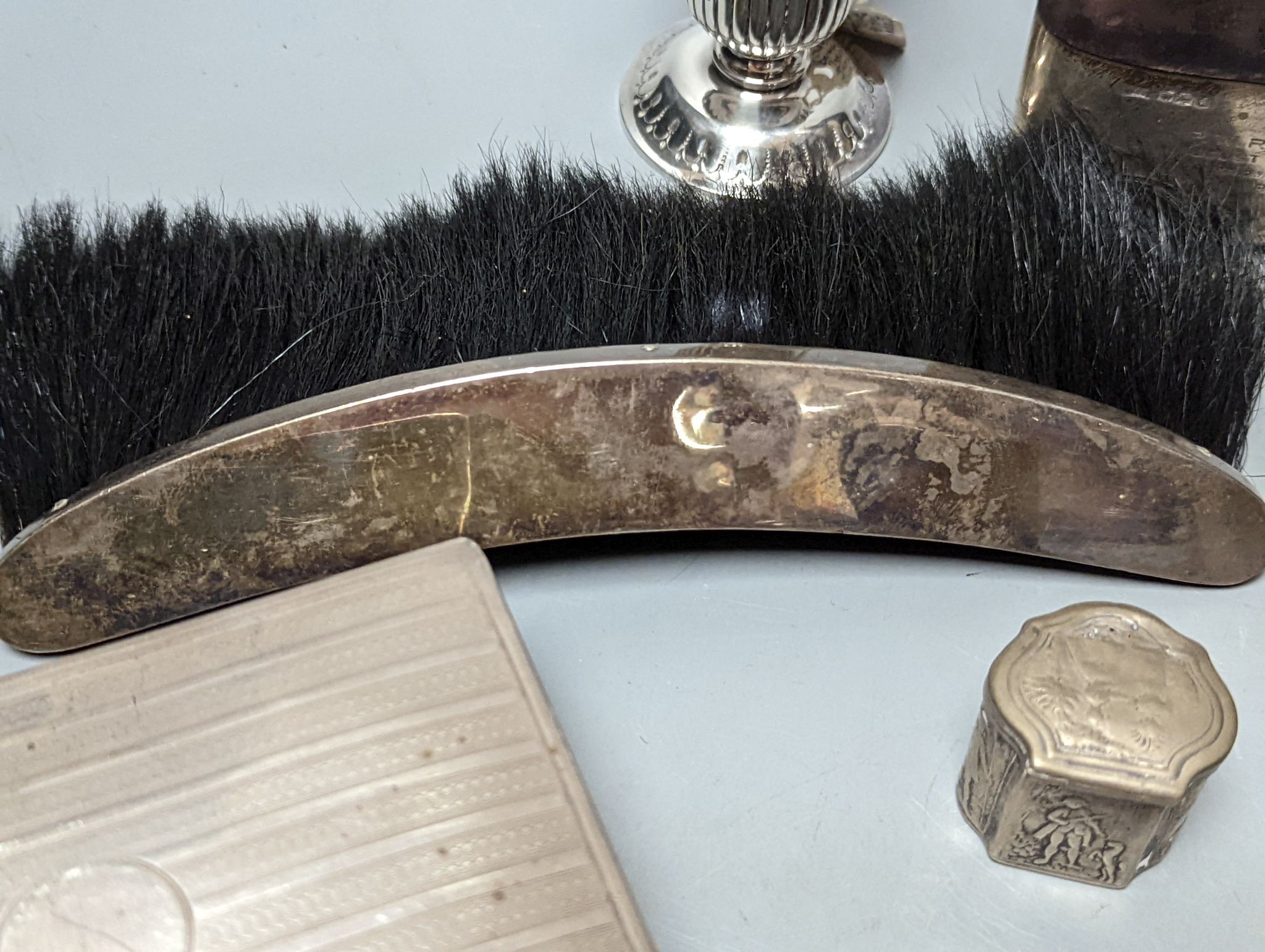 A group of assorted silver items including George V silver mounted hip flask(bruise), a pair of silver sauceboats(a.f.) one other sauceboat, sterling box, two silver cream jugs, cigarette box, salt, sugar tongs, brush an